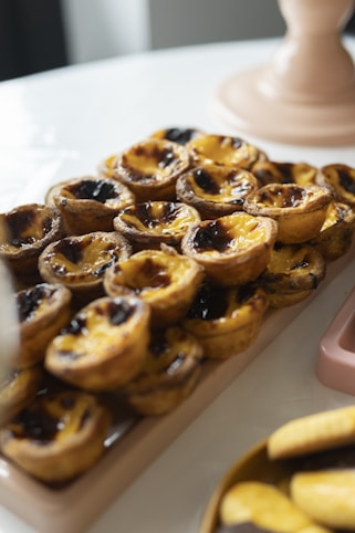 a table topped with lots of pastries next to a calculator