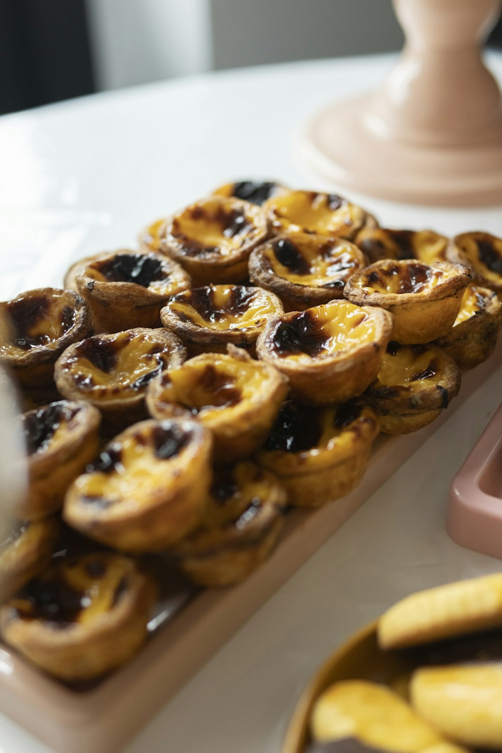 a table topped with lots of pastries next to a calculator