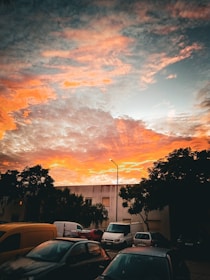 A vibrant sunset over a quiet neighborhood street.