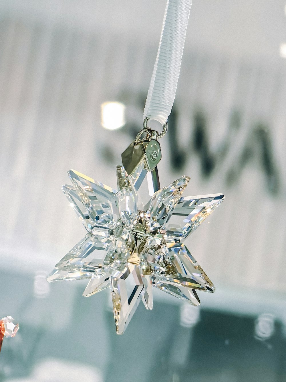a snowflake ornament hanging from a ceiling
