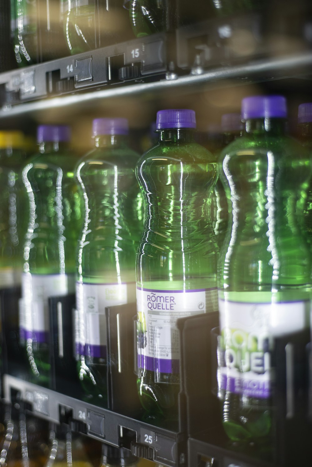 a row of bottled water bottles in a cooler