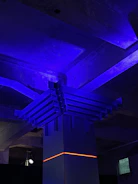 Creative team brainstorming ideas with neon blue accents in a dark room.