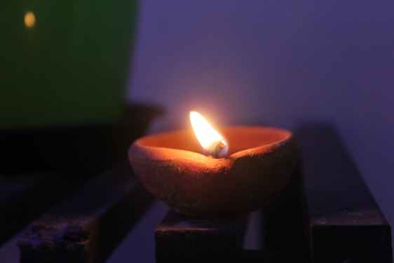 A serene image of ancient palm leaf manuscripts with a softly glowing lamp beside them.