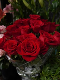 a bouquet of red roses in a glass vase