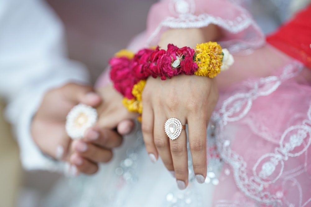 a close up of two people holding flowers