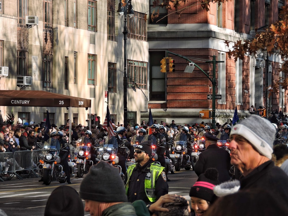 a large group of people riding motorcycles down a street