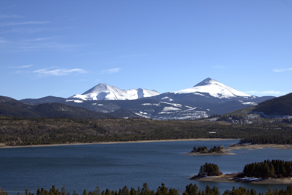 a mountain range with a lake in the foreground