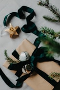 Cozy Christmas gift wrapped with red ribbon and pine cones