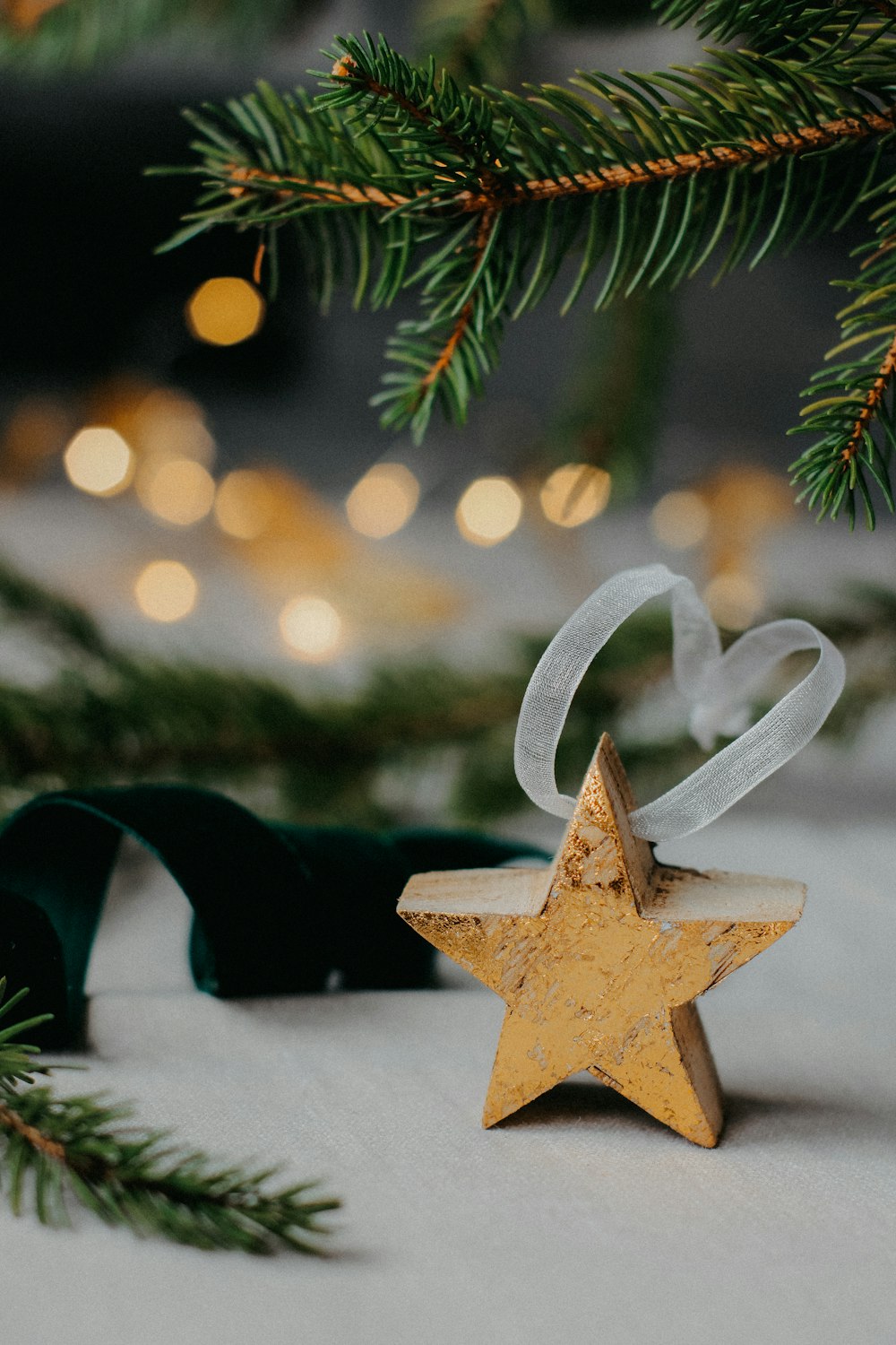 a wooden star ornament hanging from a christmas tree