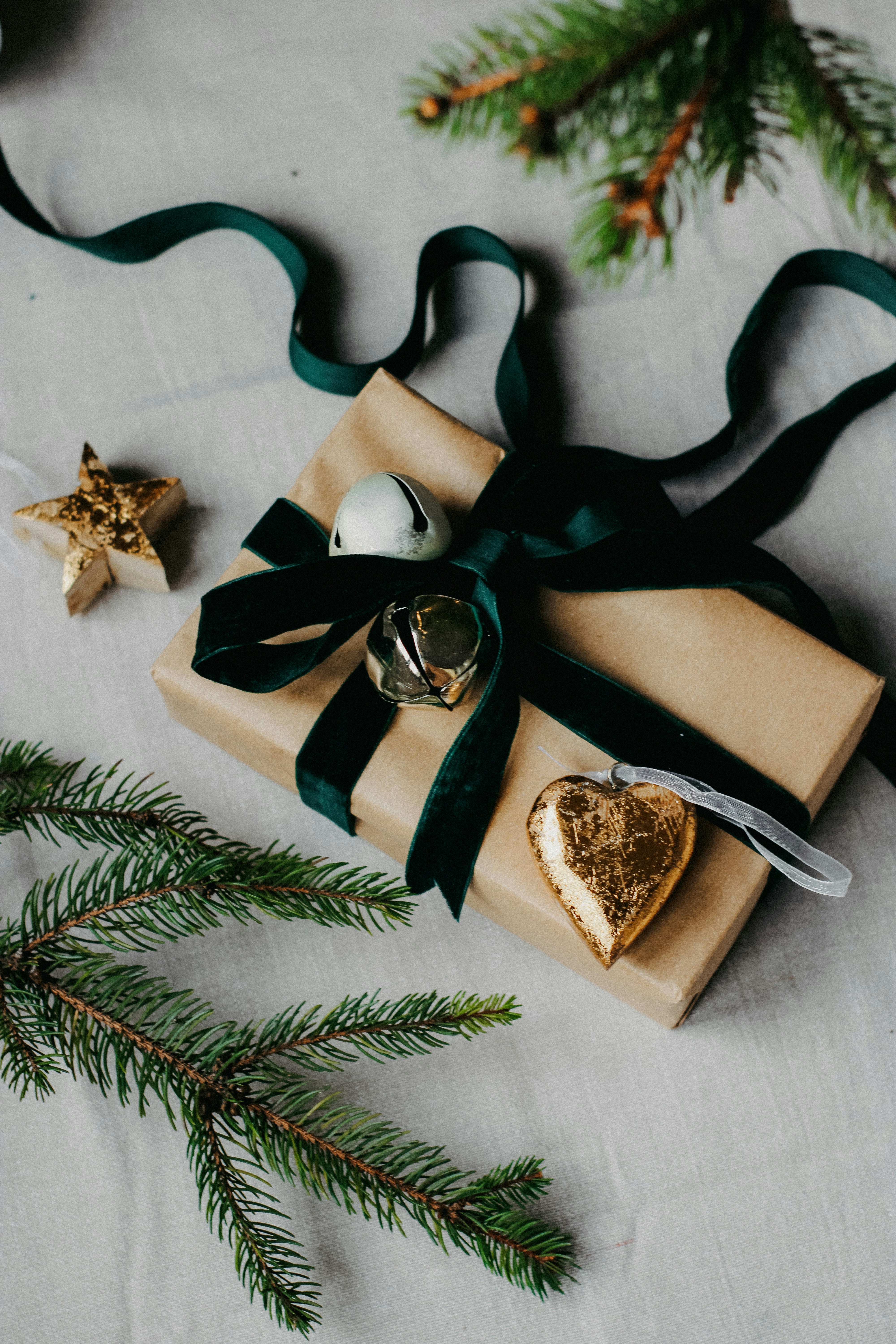 a present wrapped in brown paper with a green ribbon