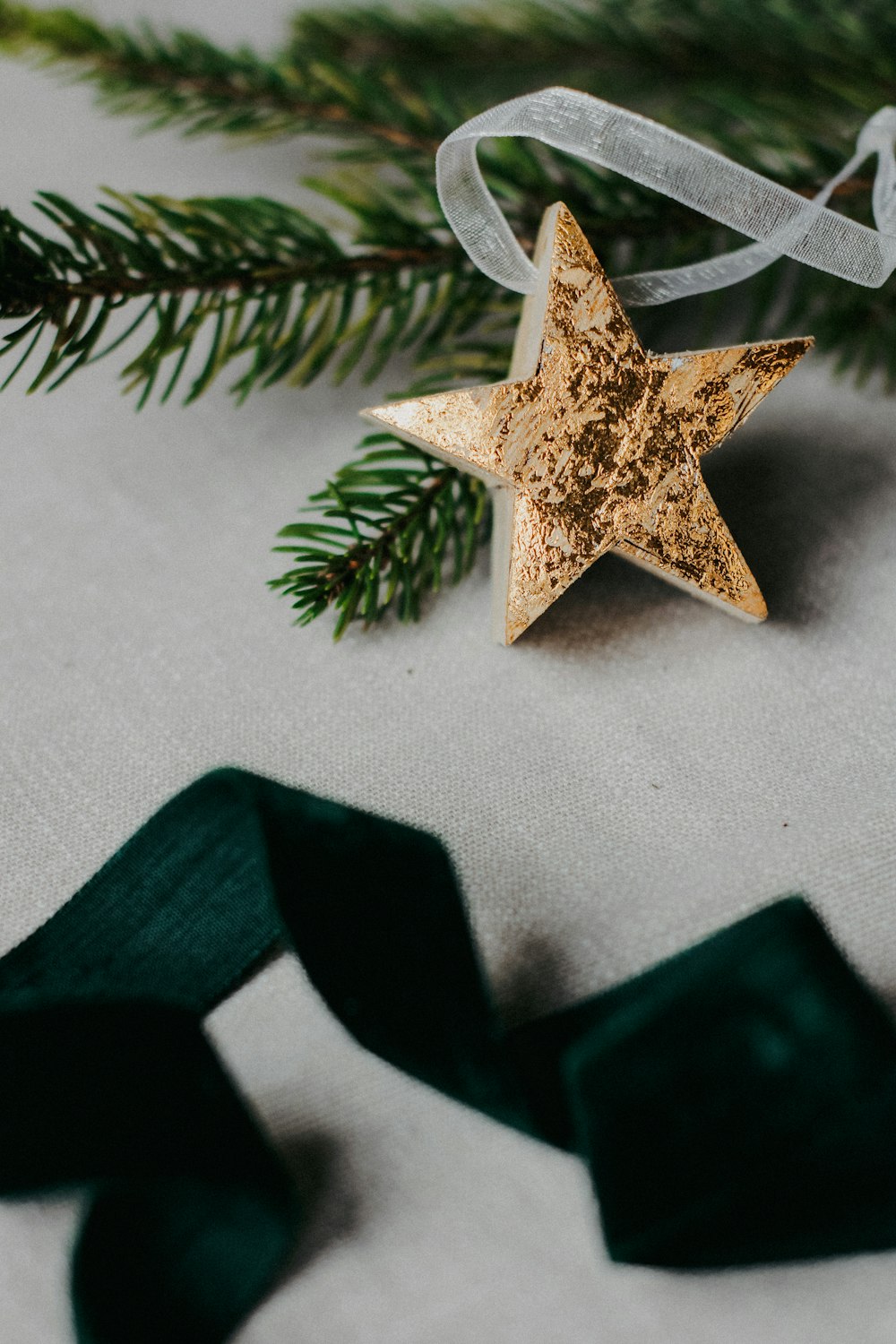 a star ornament hanging from a christmas tree