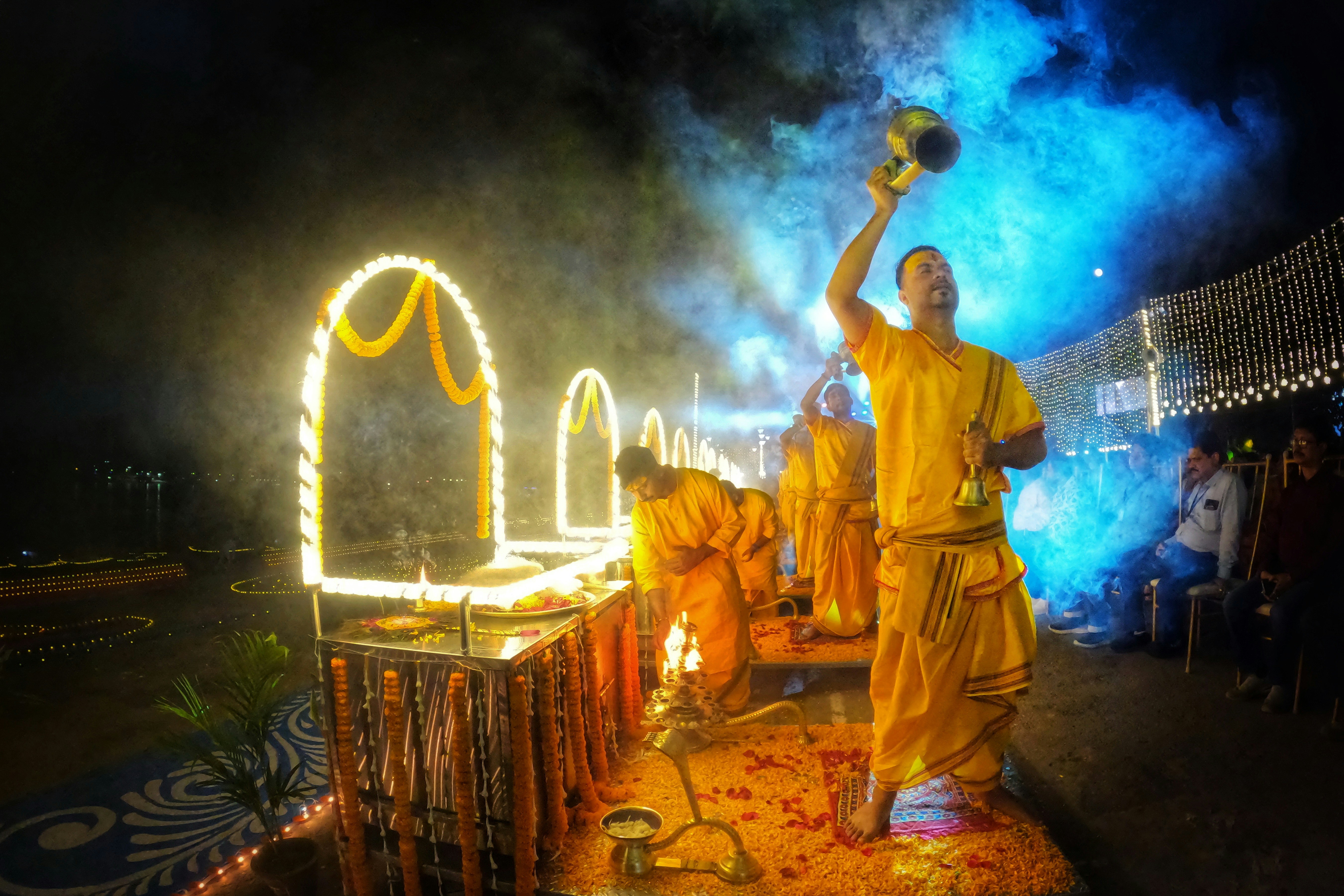 a group of men dressed in yellow performing a dance, 