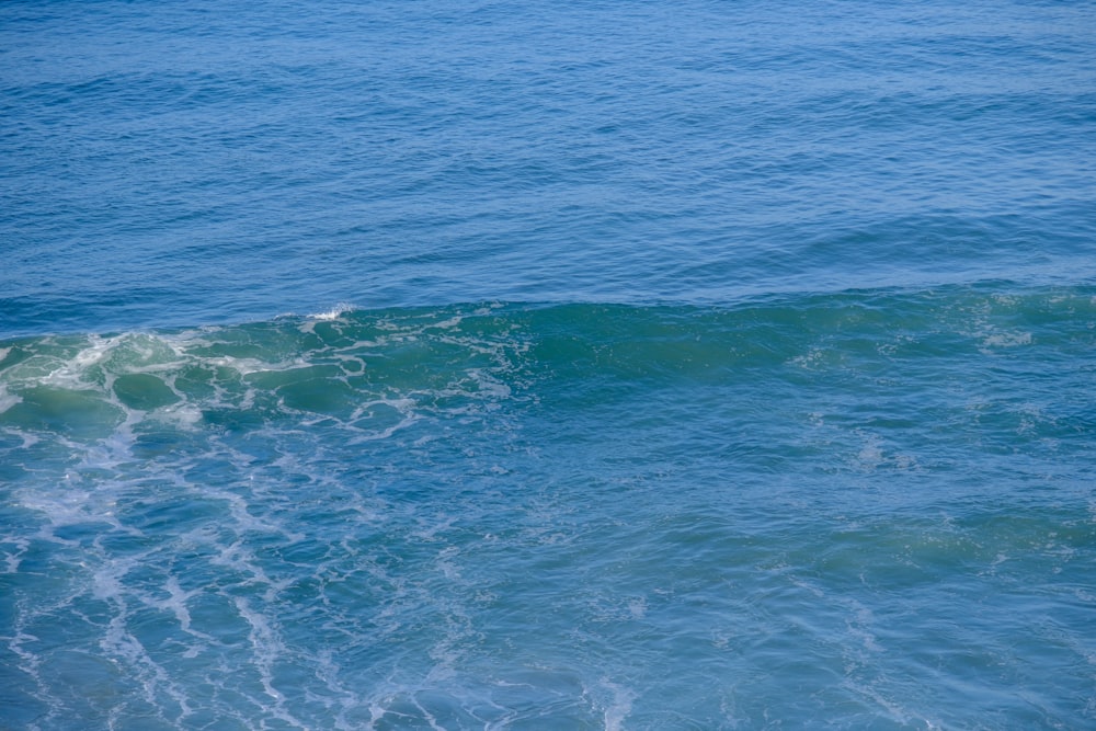 a man riding a wave on top of a surfboard