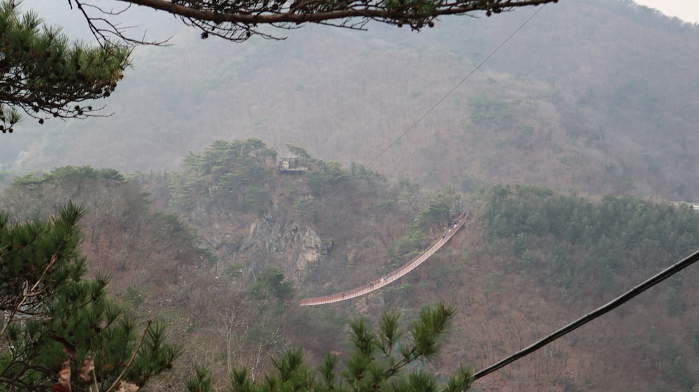 a view of a mountain with a bridge in the distance
