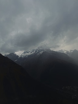 A moody, atmospheric photo of snow-covered mountain slopes hinting at the setting of 'Mandate on the Slopes.'