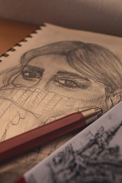 Close-up of a detailed pencil sketch showing delicate shading on a human face.
