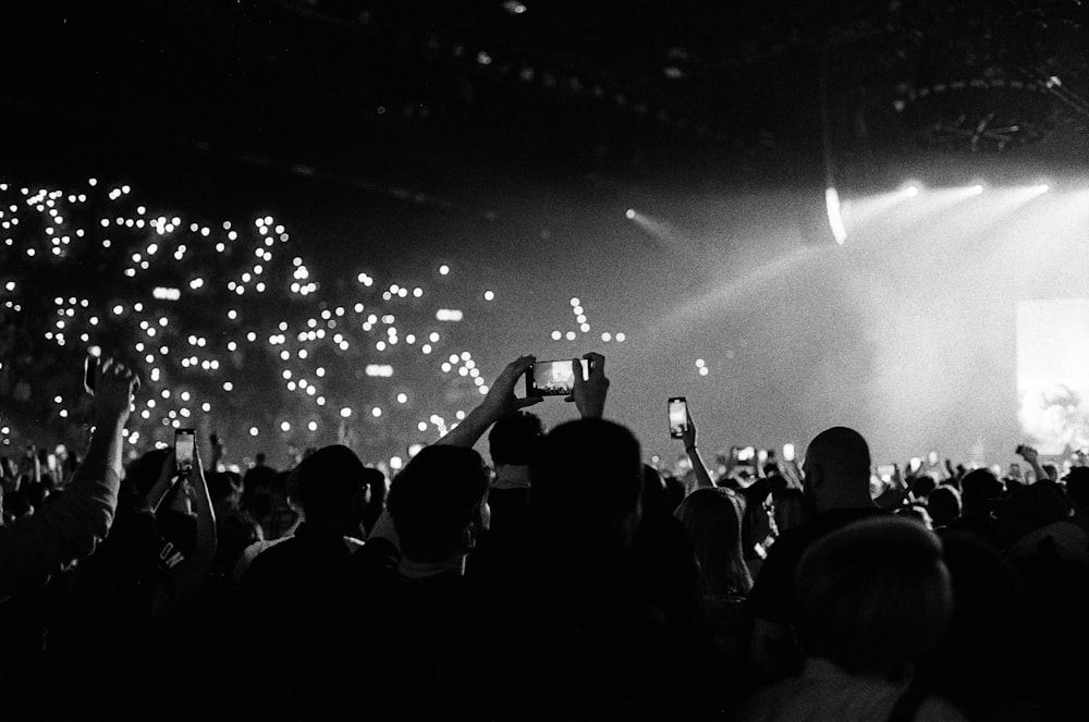 a black and white photo of a crowd at a concert