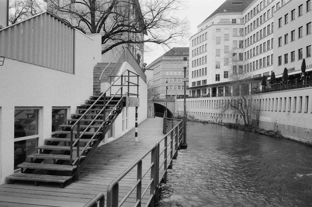 a black and white photo of a river and buildings