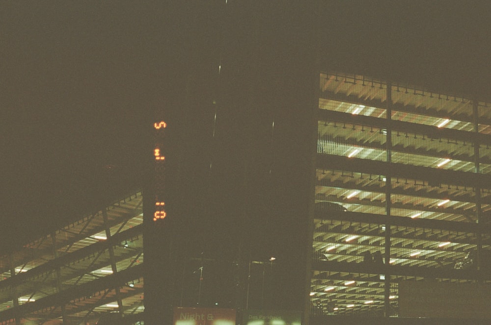 a tall building with a lit up sign in front of it