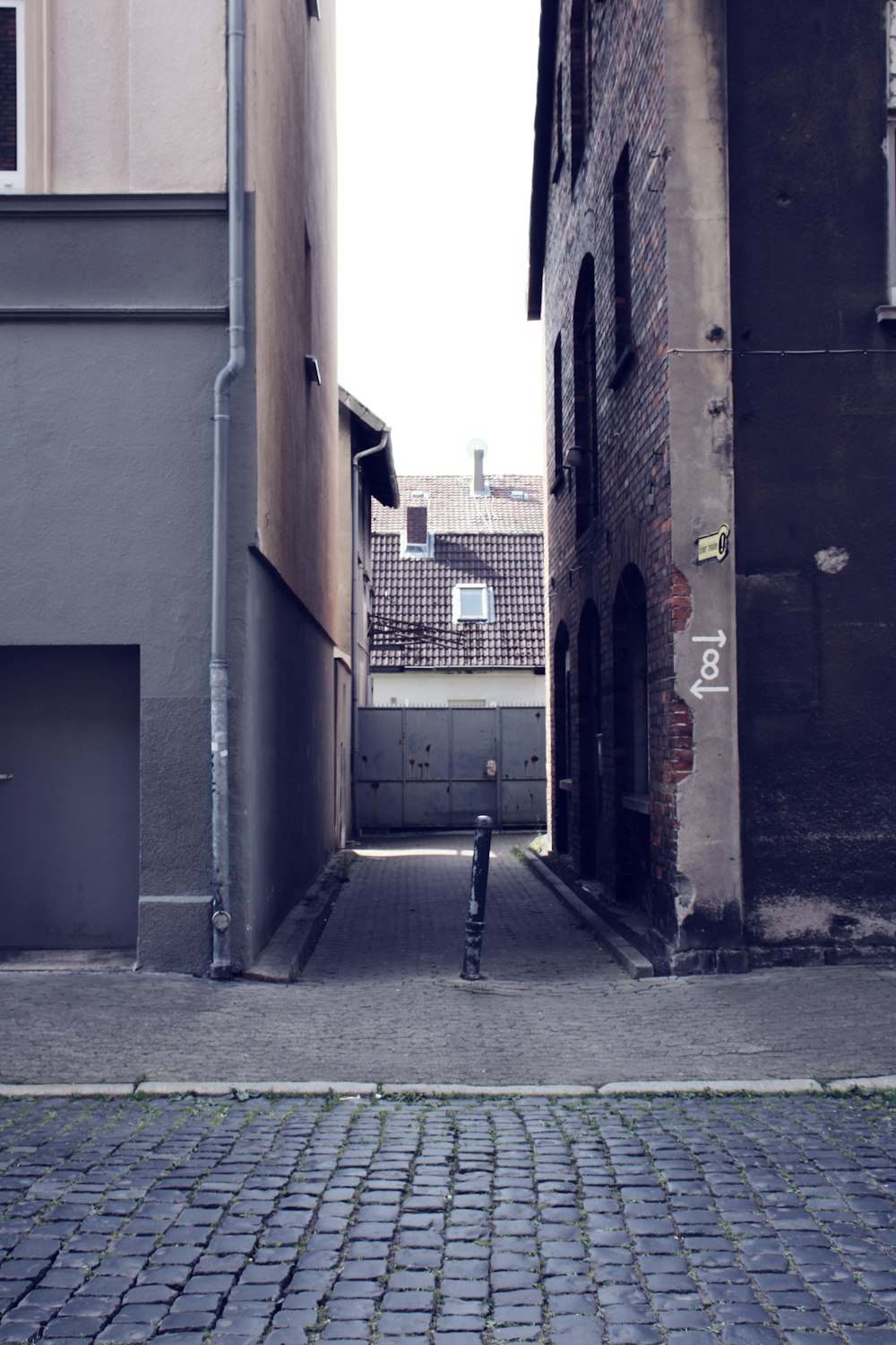 a narrow alley way with a person standing in the middle