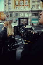 A surrogate walking through a vibrant city street, streaming live video to a remote explorer.