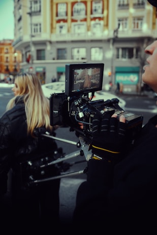 A surrogate walking through a vibrant city street, streaming live video to a remote explorer.