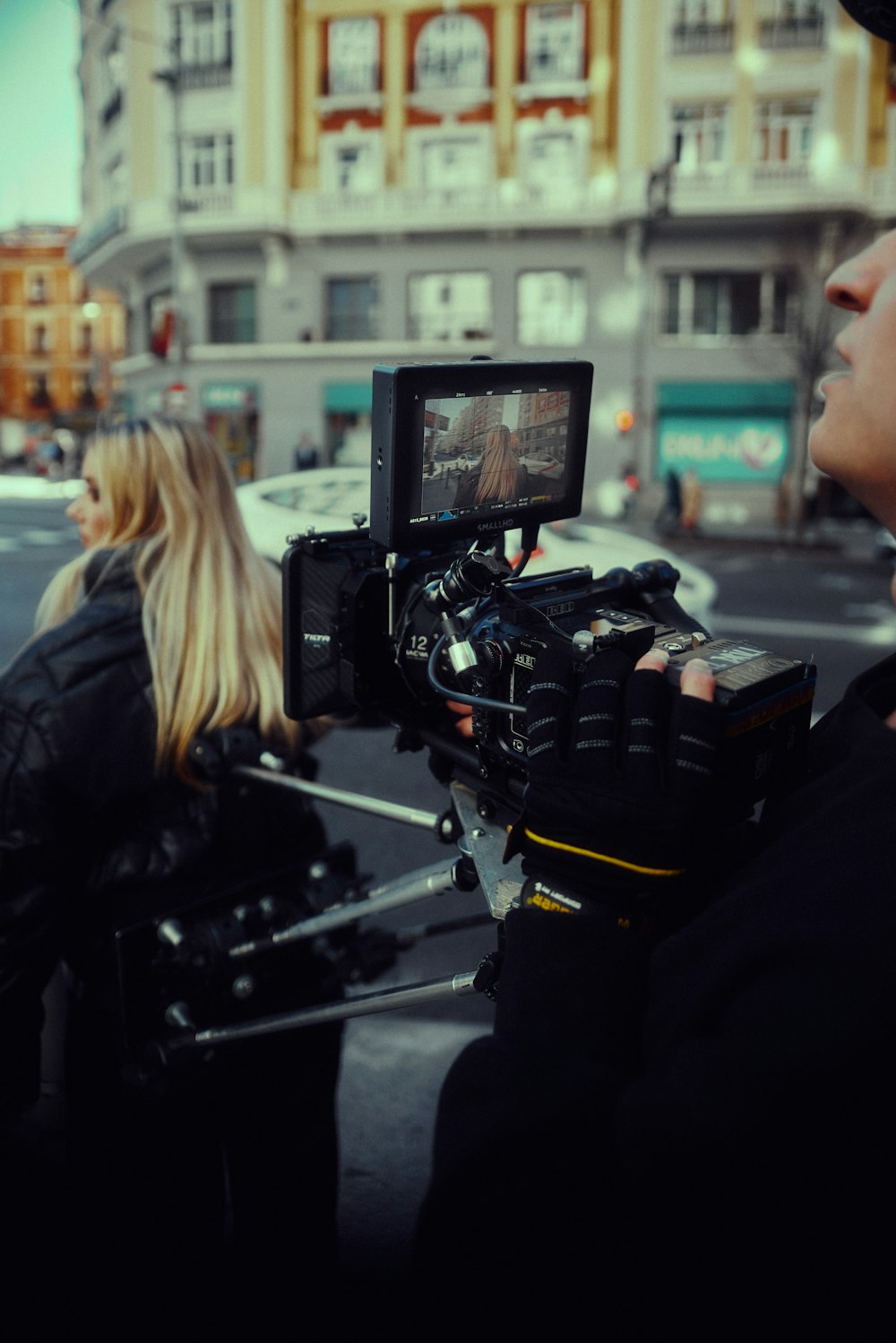 a man and a woman standing in front of a camera