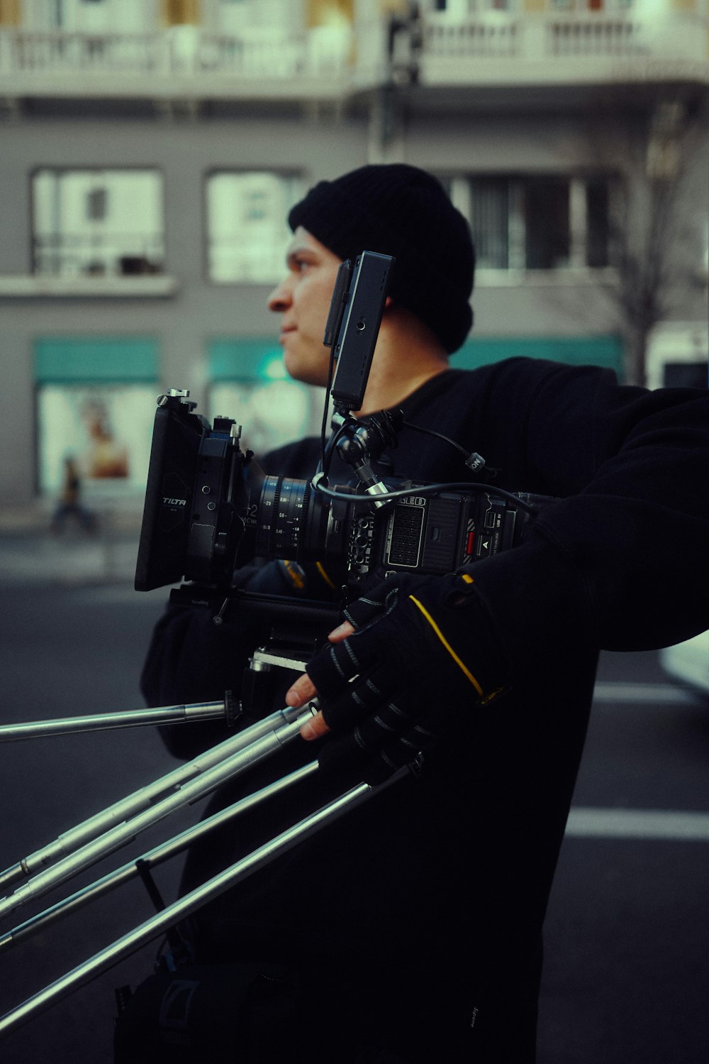 a man holding a camera on a city street