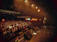 A vibrant crowd dancing under neon lights at a packed Venus Live concert.