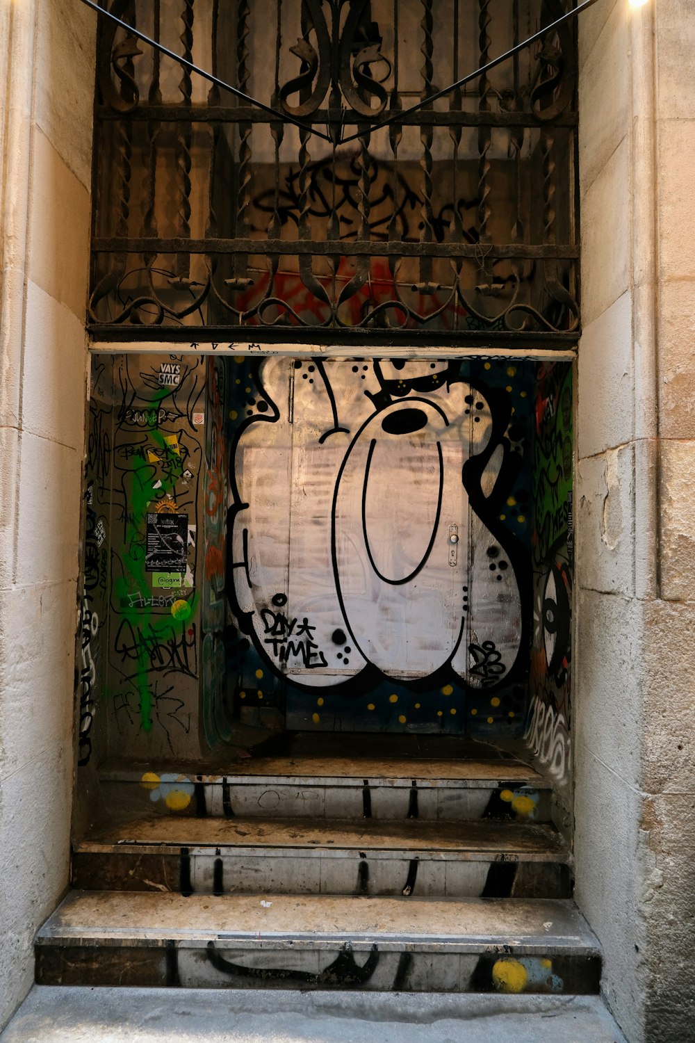 a doorway with a bunch of graffiti on it