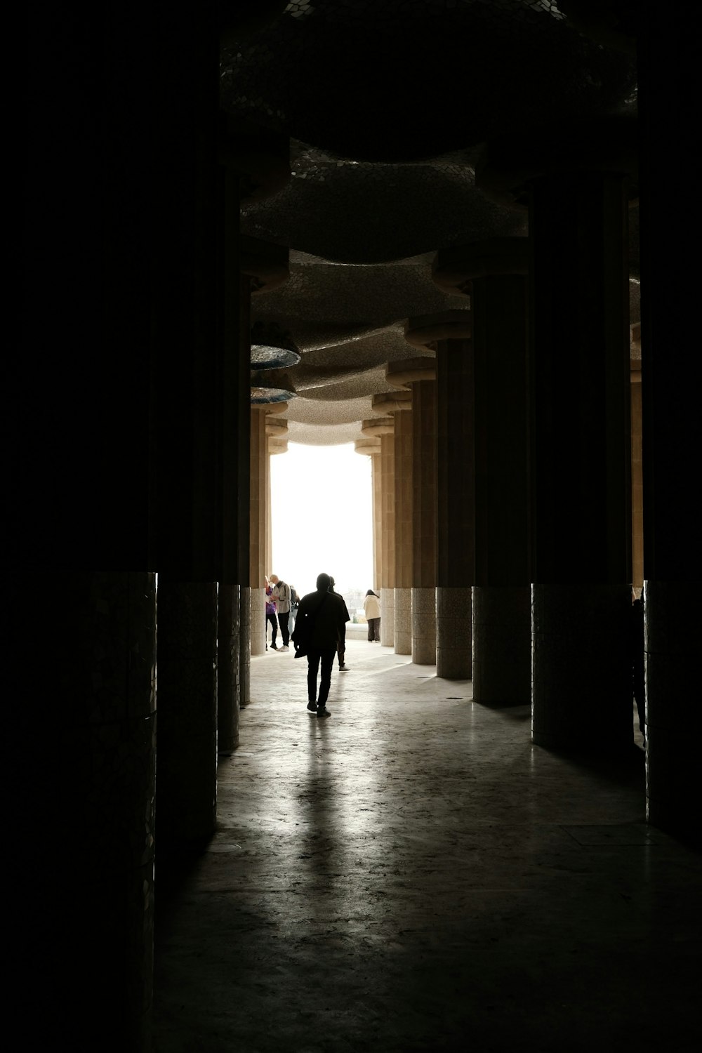 a group of people walking down a dark hallway