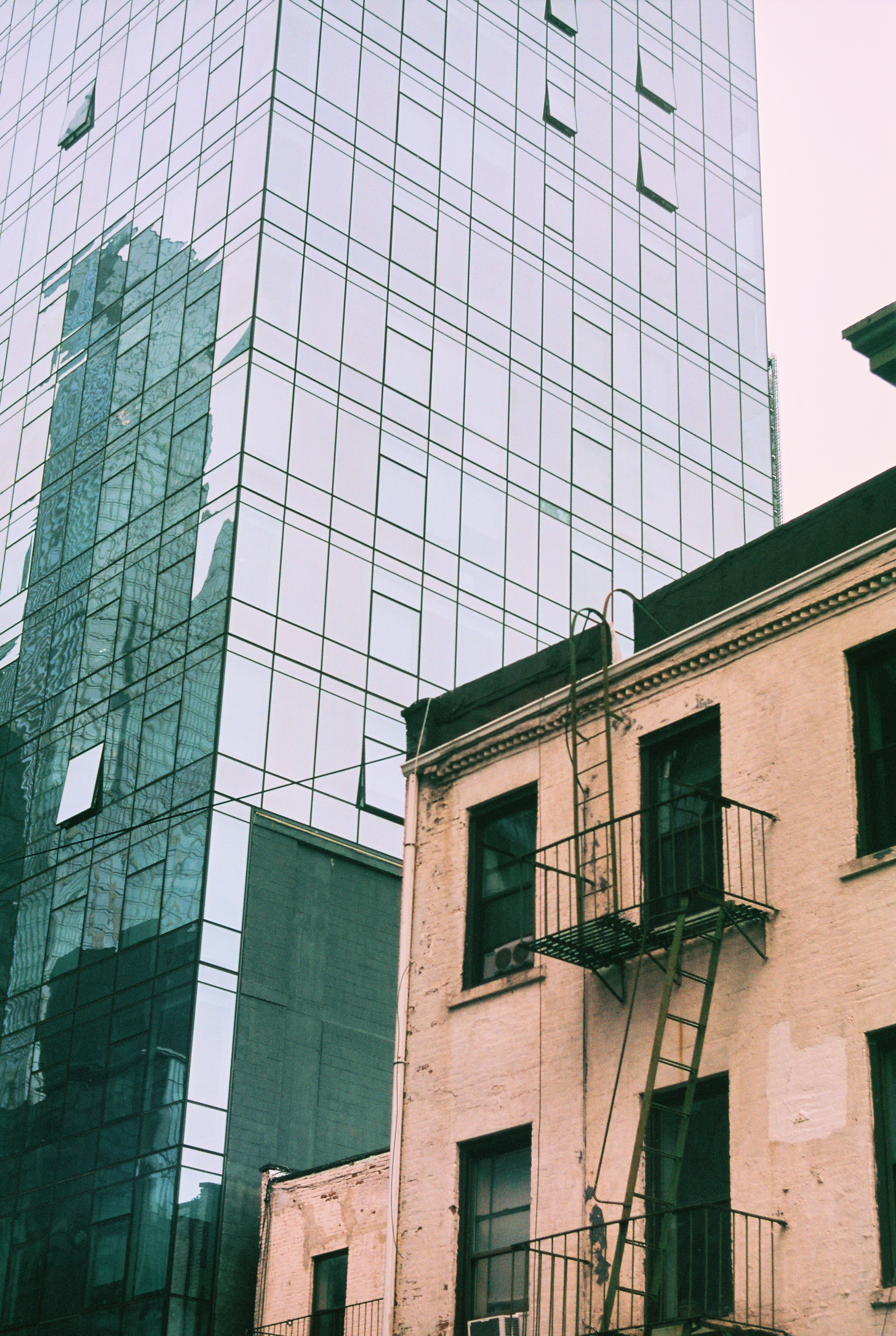 a fire hydrant sitting next to a tall building