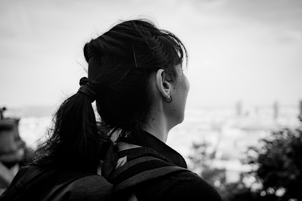 a black and white photo of a woman with a ponytail