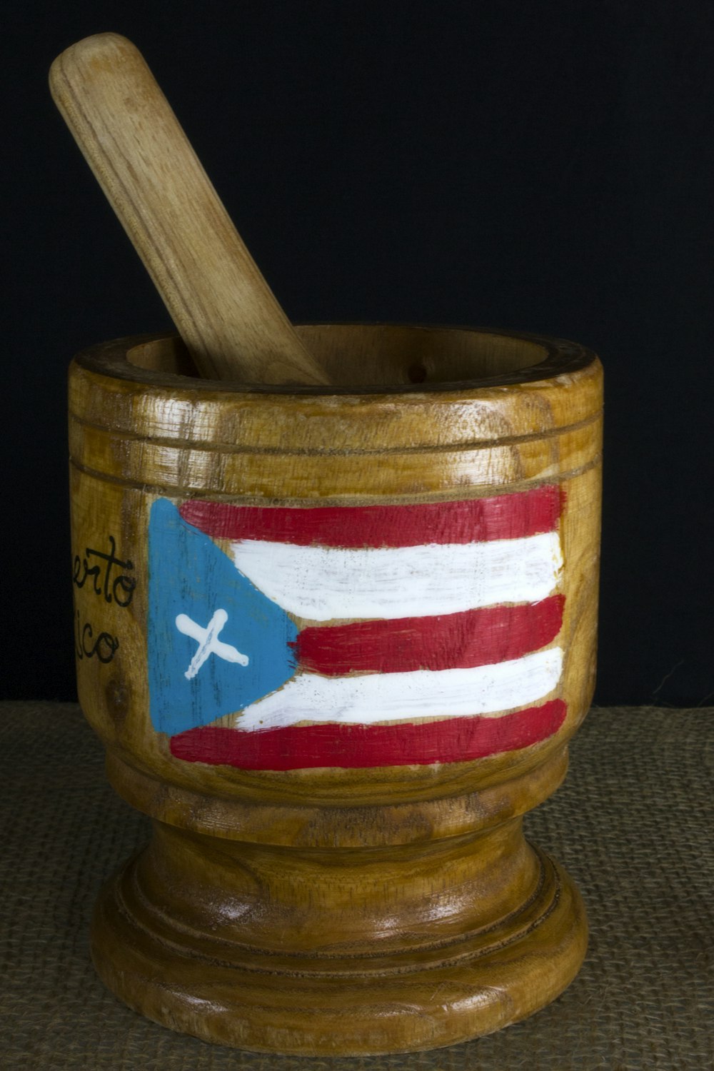 a wooden cup with a flag painted on it