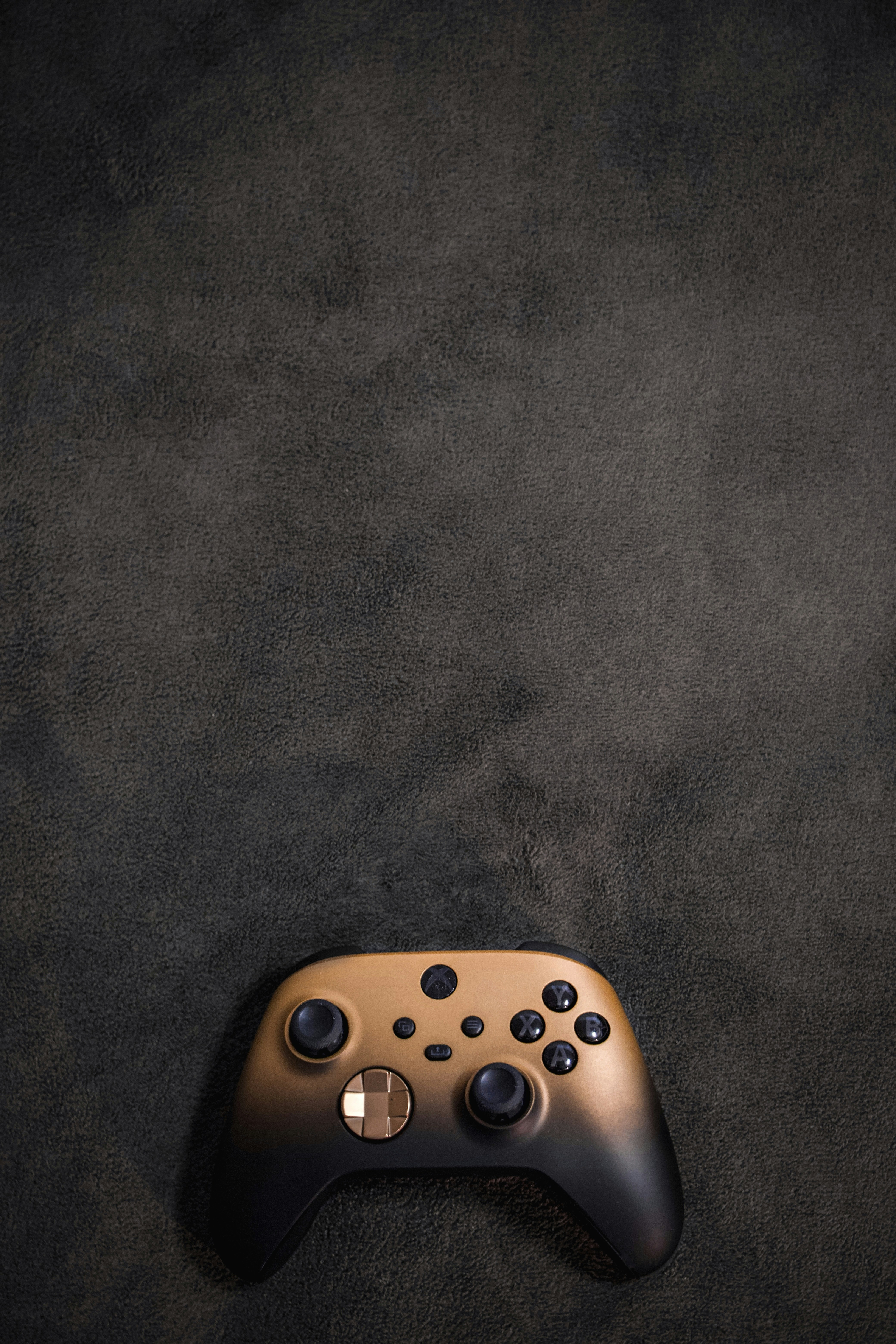 a close up of a controller on a black surface