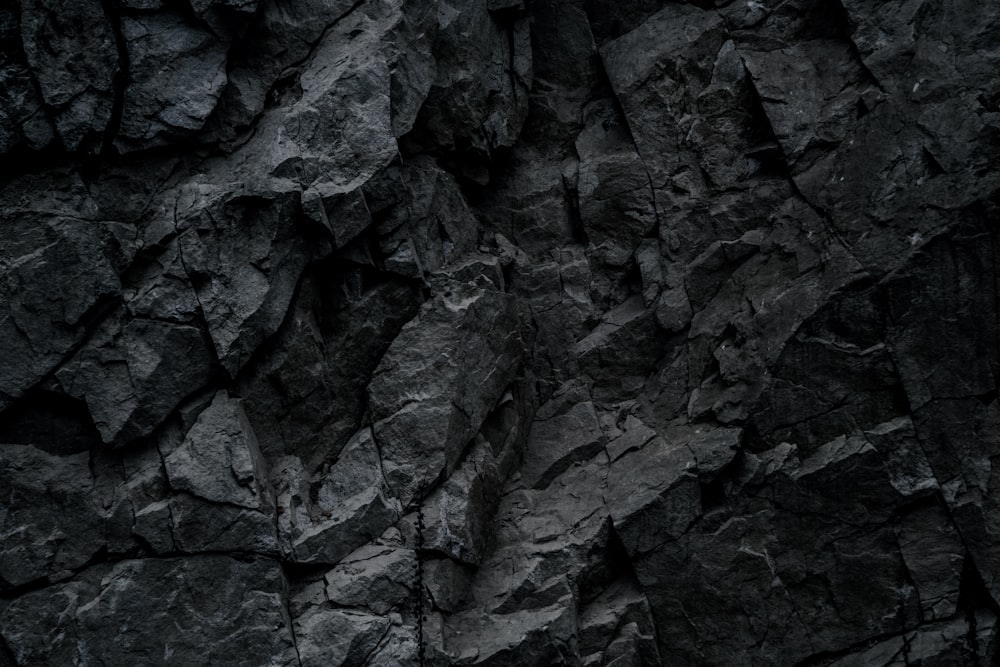 a close up of a black rock wall