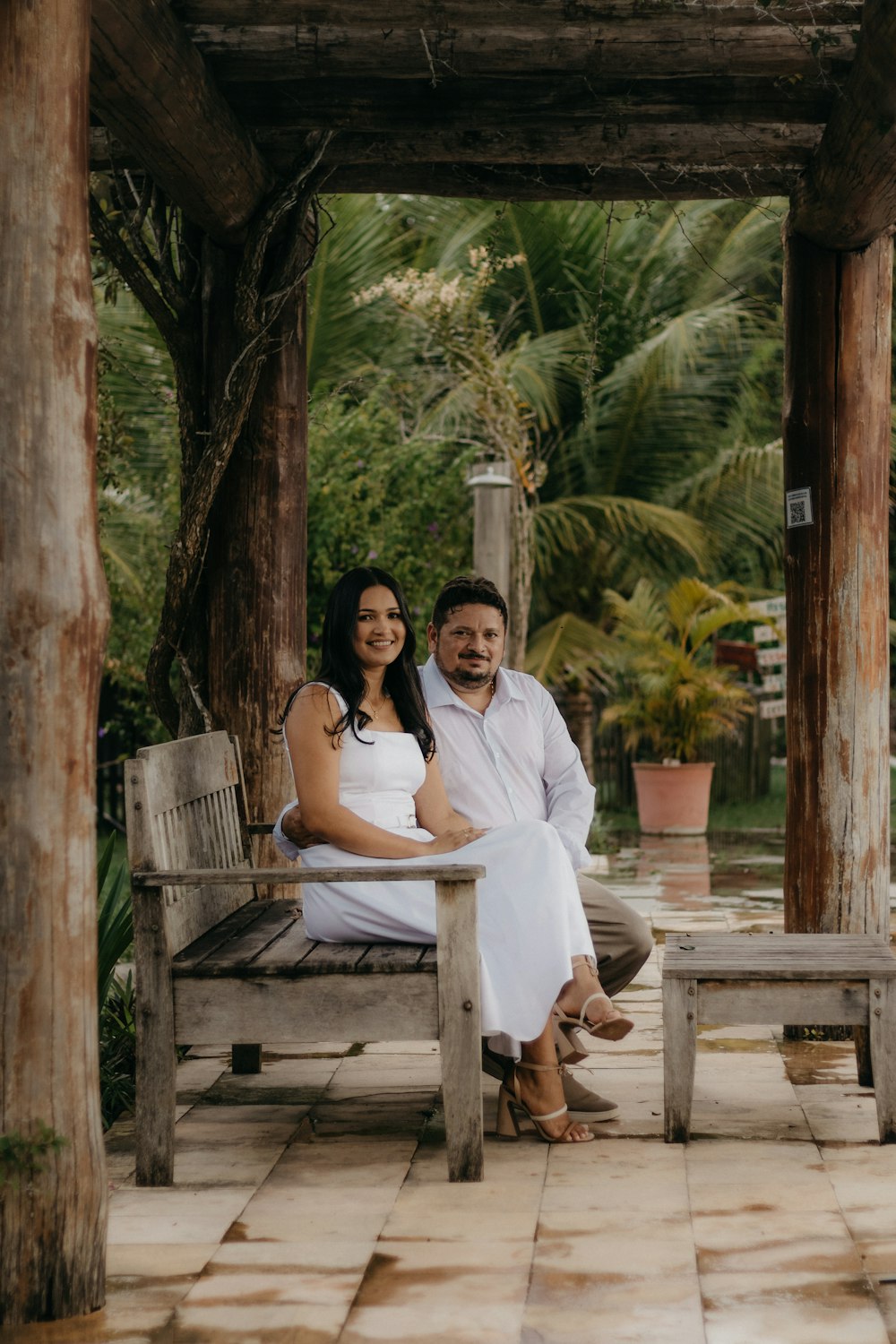 a man and a woman sitting on a bench