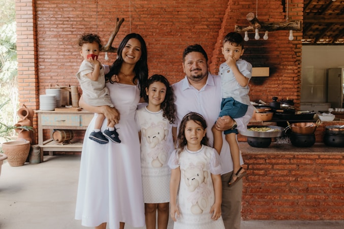 a family posing for a picture in a kitchen