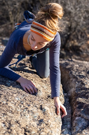 Outdoor adventurer climbing rocky terrain with durable sports bandages securing their joints.