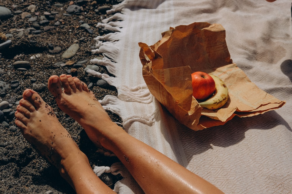 a person laying on a towel on the beach