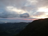 A scenic view of a mountain landscape during sunset.