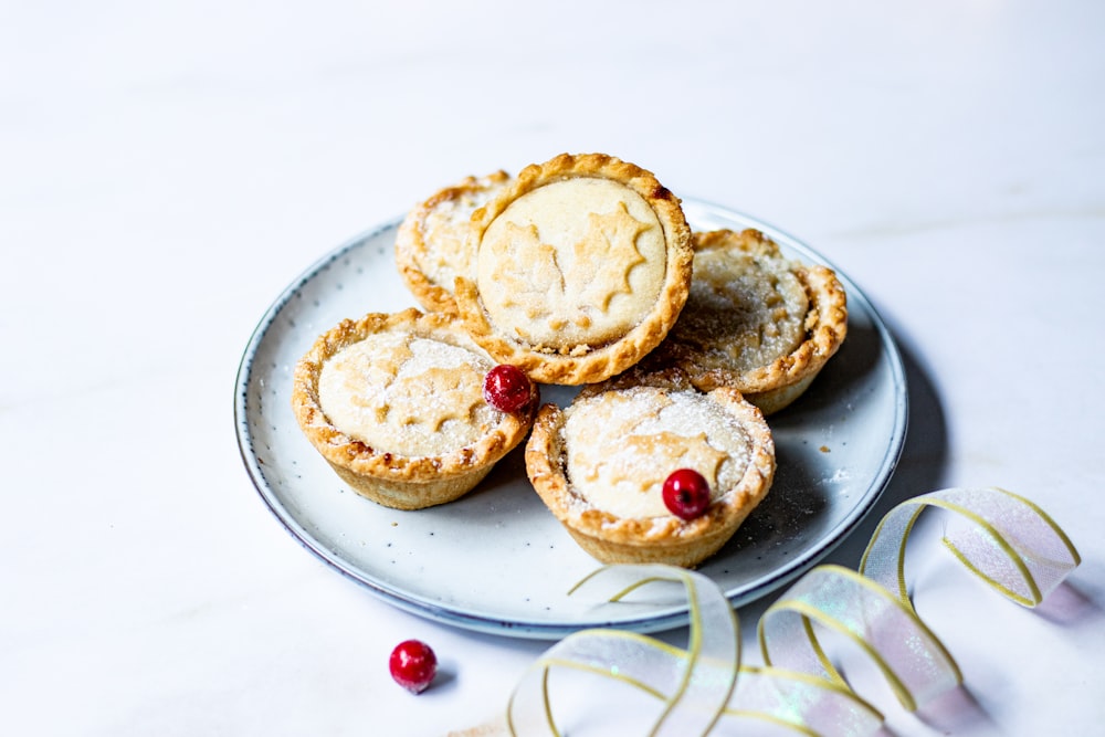 a white plate topped with mini pies on top of a table