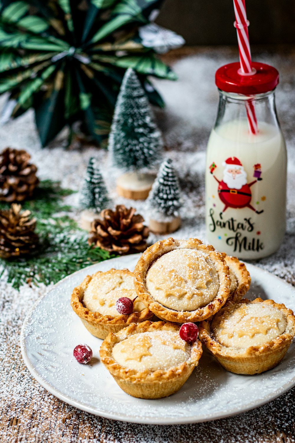 a white plate topped with cookies next to a bottle of milk