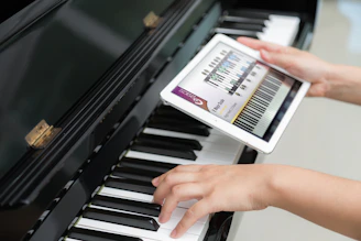 Keyboard tutorial displayed on a sleek tablet with notes and chords highlighted.
