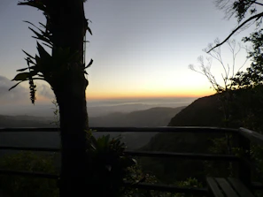 Balcony view from the deluxe room showcasing serene valley landscapes at sunset.