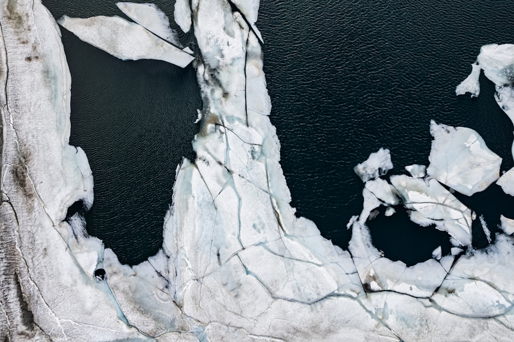 an aerial view of a large iceberg in the water