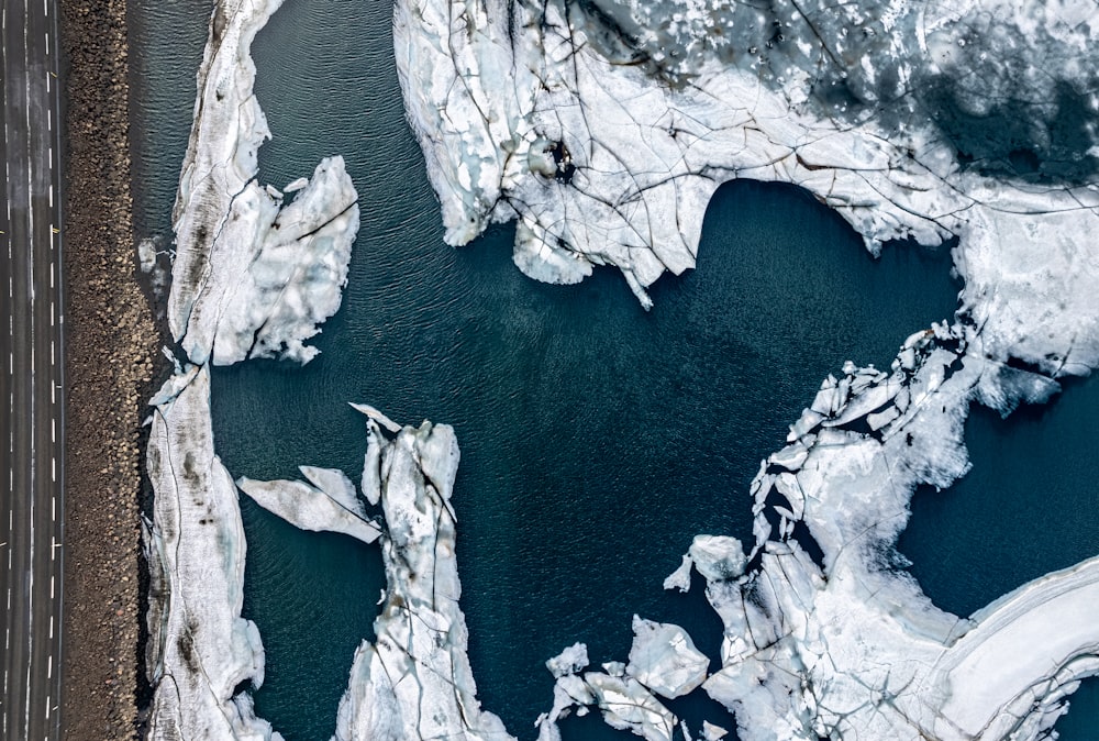 an aerial view of a road and a body of water