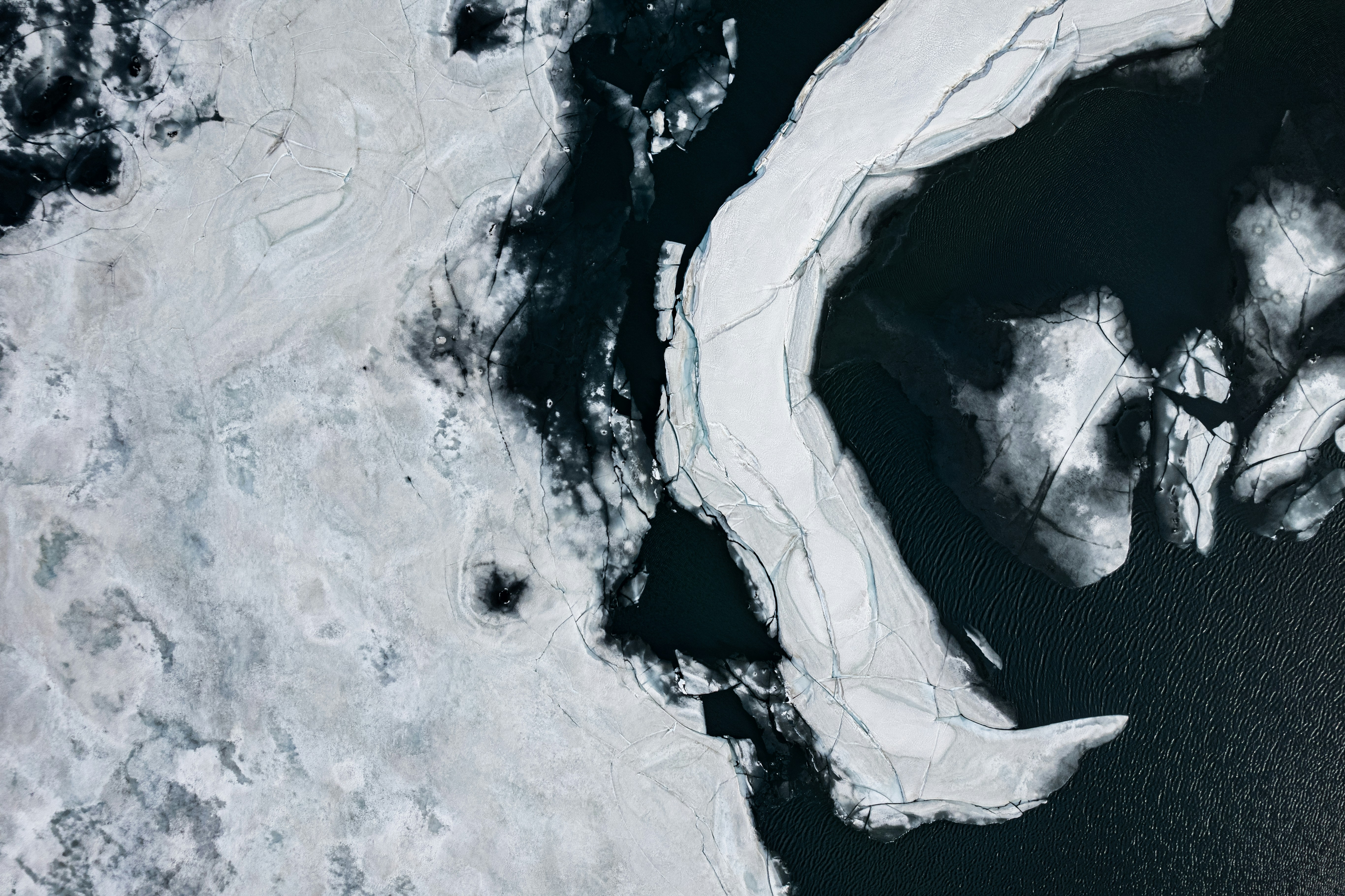 an aerial view of a body of water covered in ice
