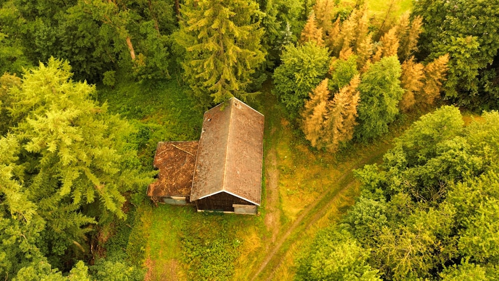 an aerial view of a cabin in the woods