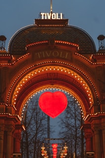 a large heart is lit up in front of a building